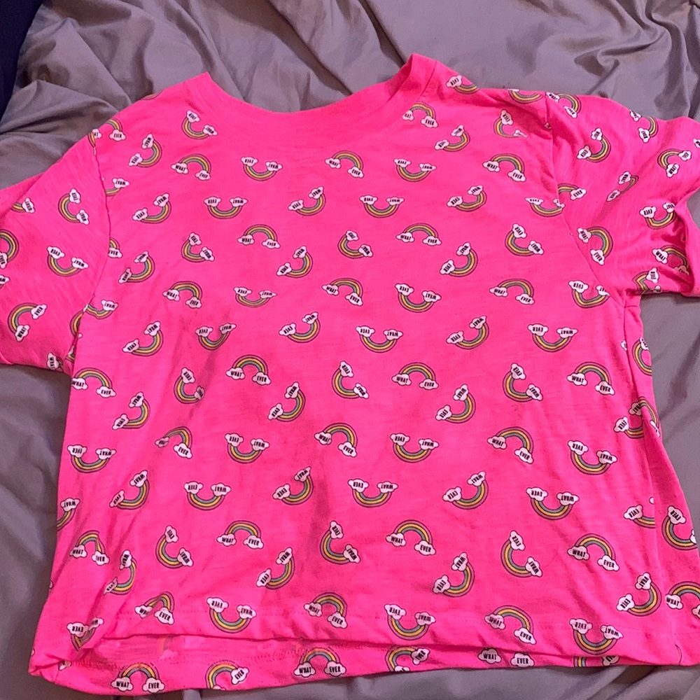 Pink shirt, “whatever” on the shirt, rainbows.